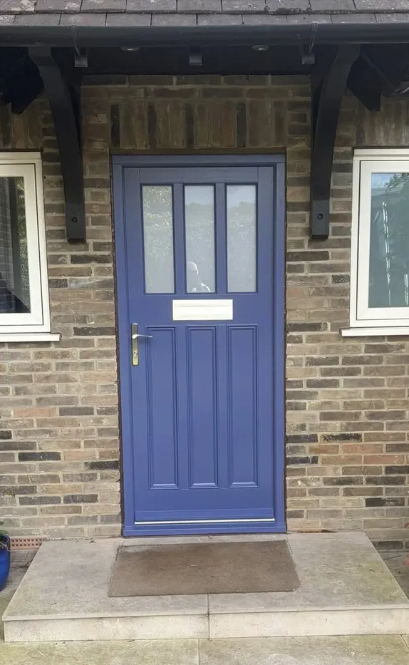 Accoya blue 1930s-style front door with three glazed lights over vertical panels, letterplate and brass-coloured lever handle