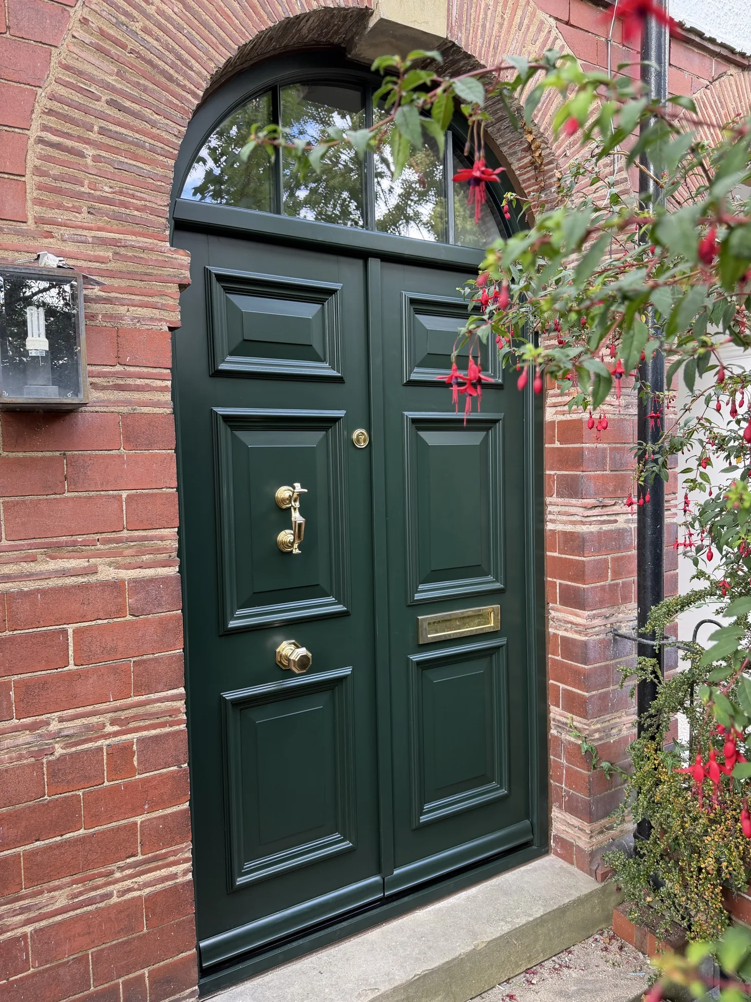 Brass door knocker, letterplate and escutcheon on Accoya arched front door — Fulford, York. Handcrafted timber by Bailey Hague Joinery, Yorkshire.
