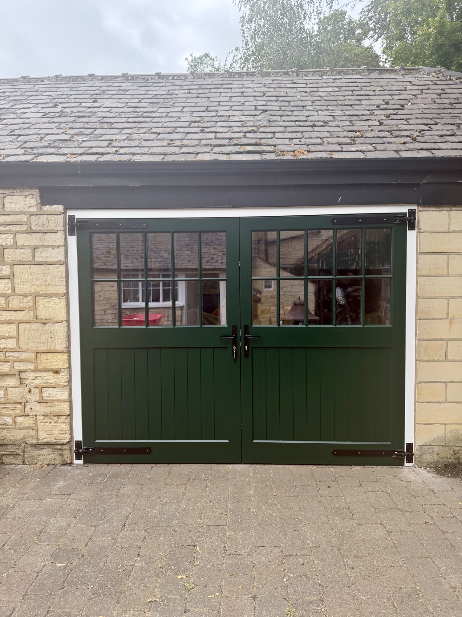 Racing Green Accoya garage doors installed in Saxton, North Yorkshire