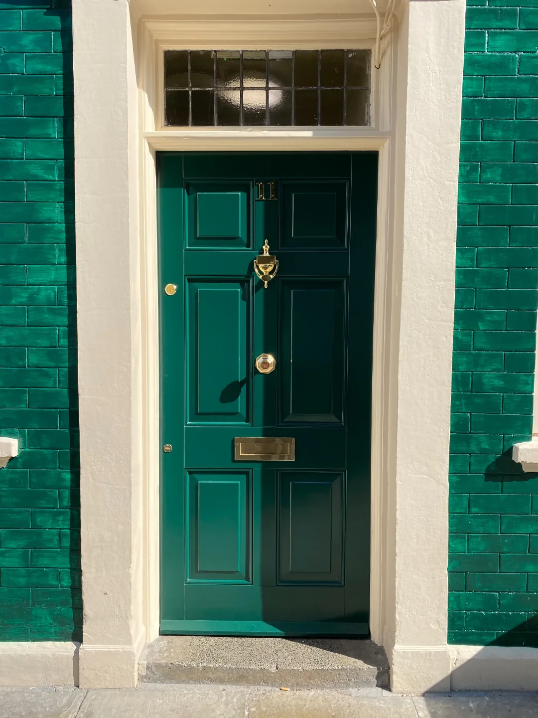 Emerald green Georgian 6-panel front door with brass urn knocker, letterplate and knob — bespoke Accoya heritage door by Bailey Hague Joinery, York.