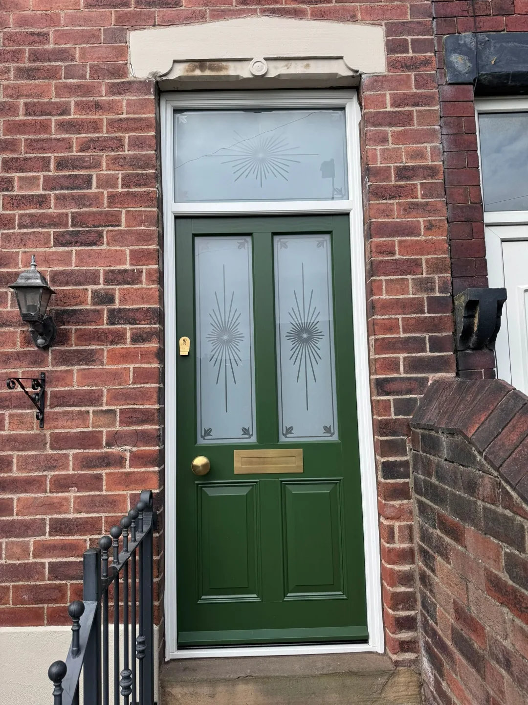 Bottle green Victorian front door with brass hardware and starburst etched glass transom — bespoke heritage door by Bailey Hague Joinery, Yorkshire.