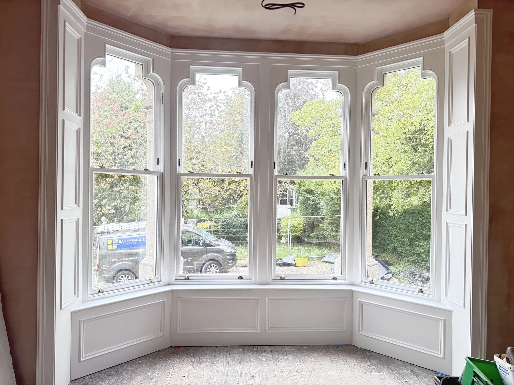 Curved bay of white Accoya sash windows with trefoil heads at Queens Road, Harrogate