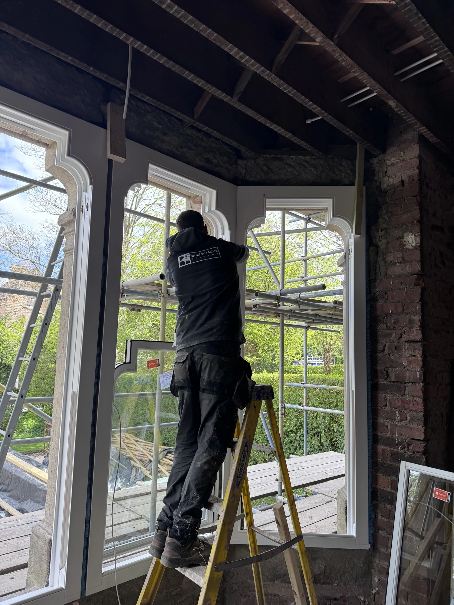Bailey Hague Joinery fitter installing an Accoya sash window at Queens Road Harrogate during phased site works