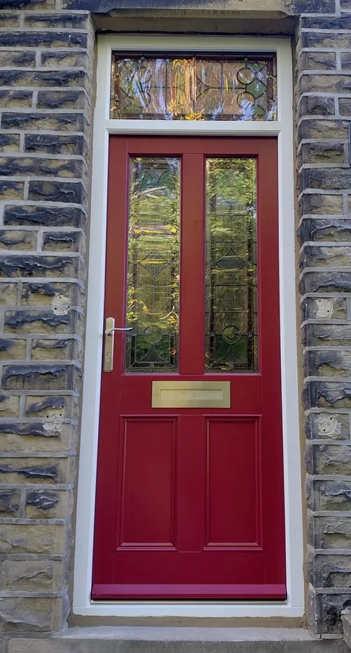 Accoya red period front door with two leaded stained-glass panels, matching leaded fanlight, brass letterplate and brass-coloured lever handle