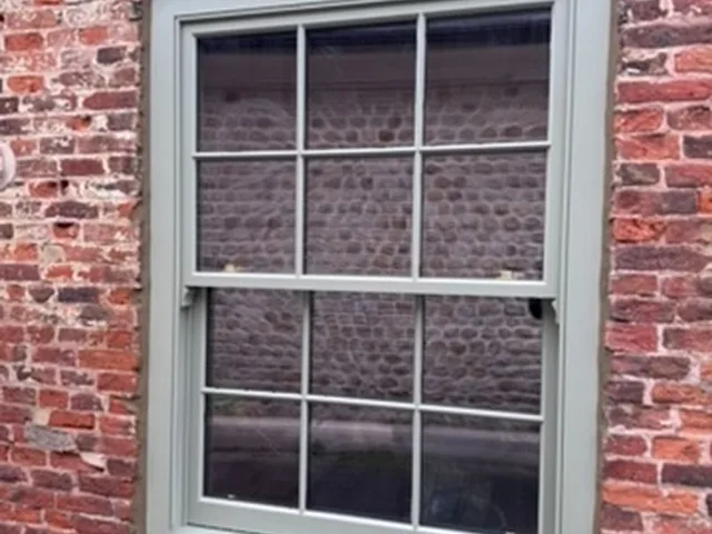 Sage timber sash window in brick cottage, Ripon