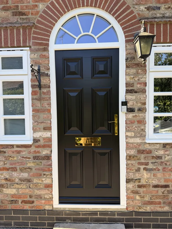Arched 6-panel entrance door with brass letterplate, lever and carriage lamp, York